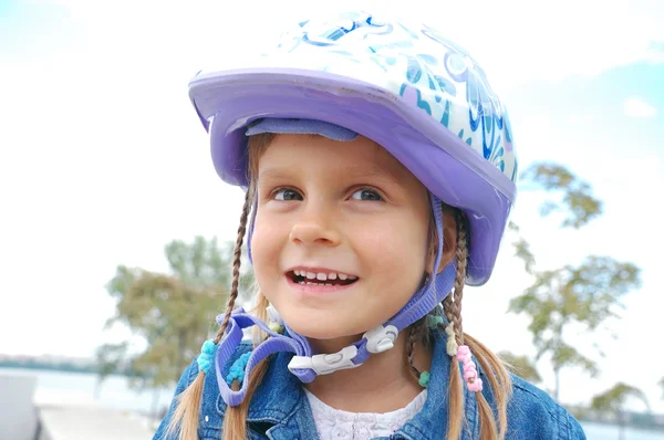 Happy girl wearing a helmet