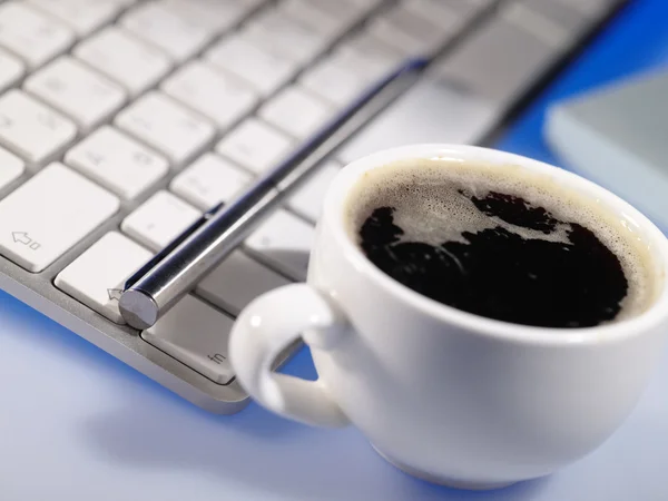 Computer keyboard with coffee cup
