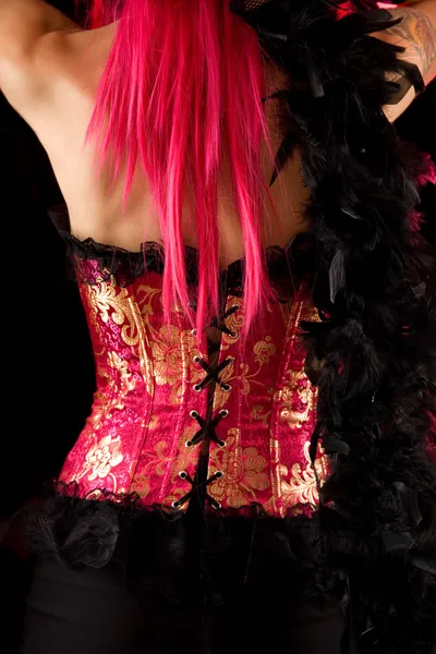 Rear view of cabaret girl in pink corset