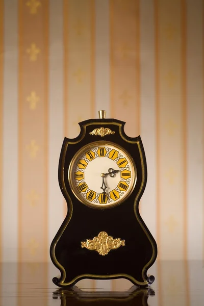 Vintage clocks on wallpaper background