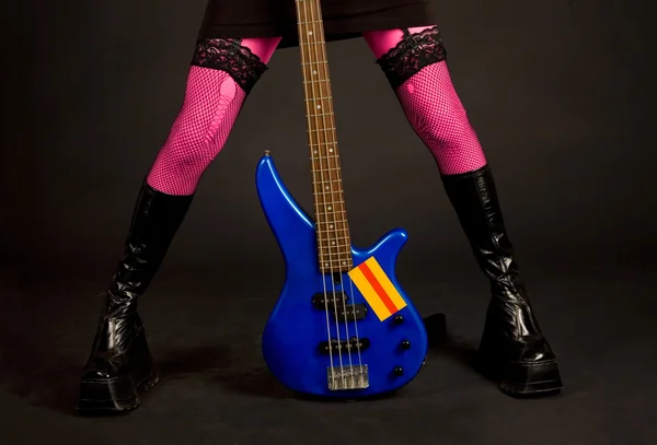 Close-up of woman legs with guitar