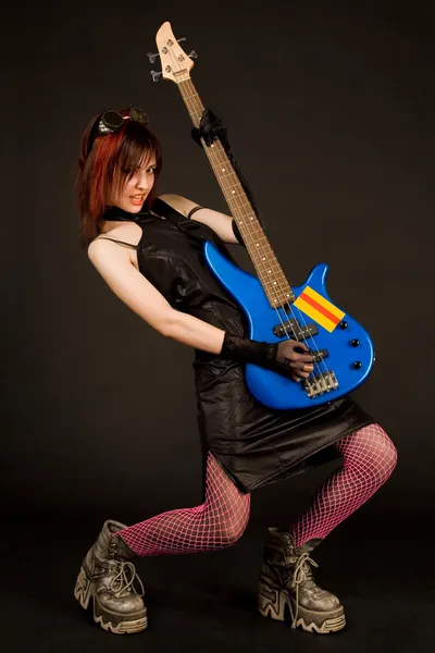 Attractive girl playing bass guitar