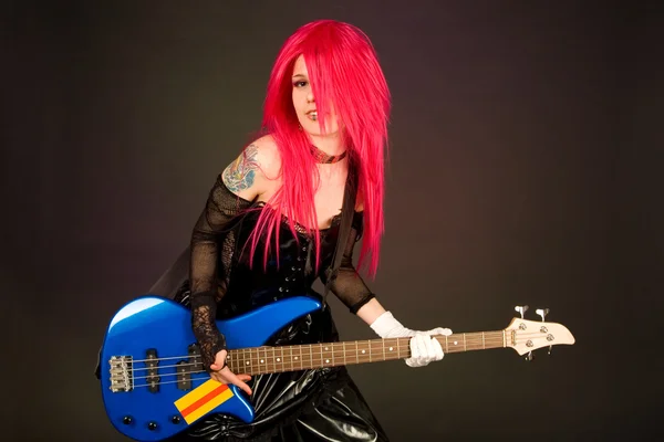 Attractive girl playing bass guitar