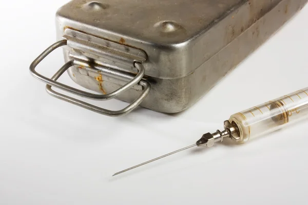 Old medical syringes and metal box