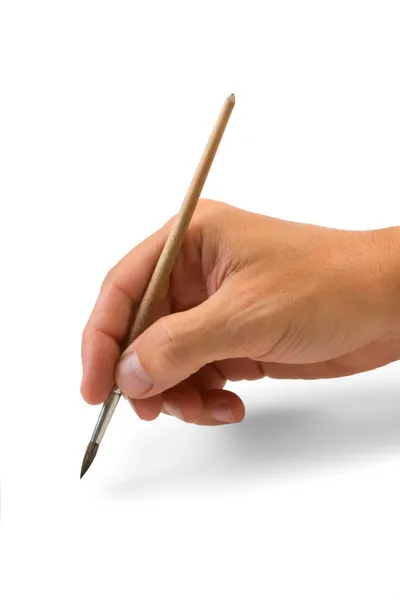 Hand holds the brush to draw