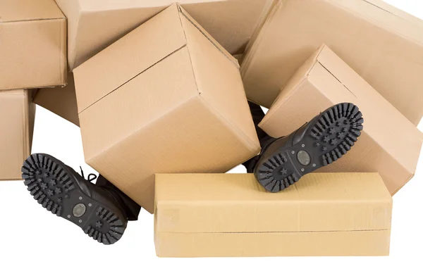 Male feet and heap of boxes