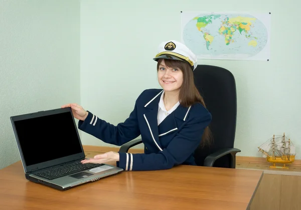 Girl in a sea uniform at office with laptop