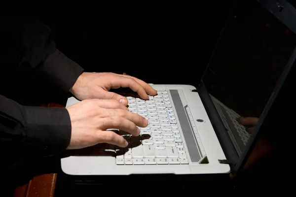 Man\'s hands on the laptop keyboard