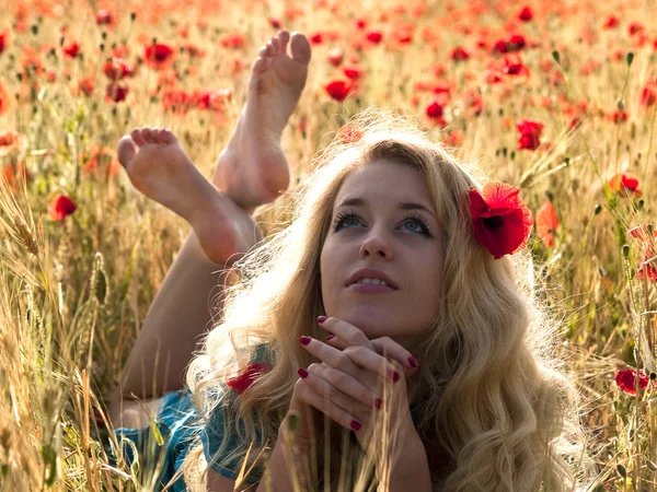 Barefoot blonde in poppies