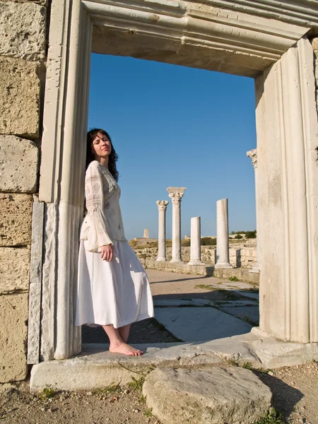 Barefoot Girl Leaning Ancient Ruins by Anton Hlushchenko Stock Photo