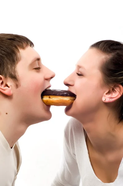 Beautiful young couple eating donut