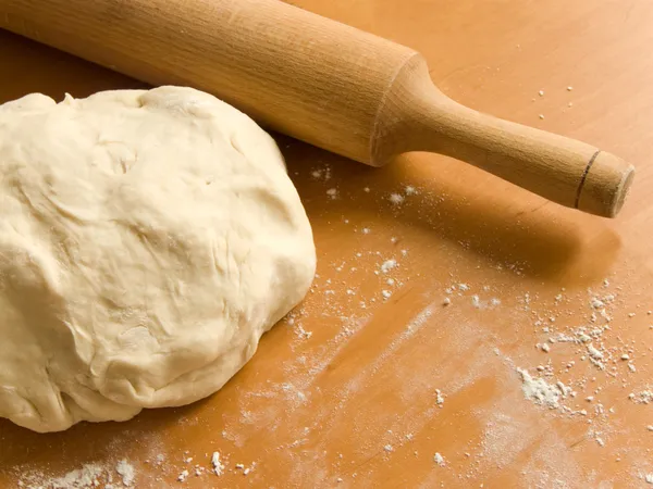 The fresh dough and rolling pin