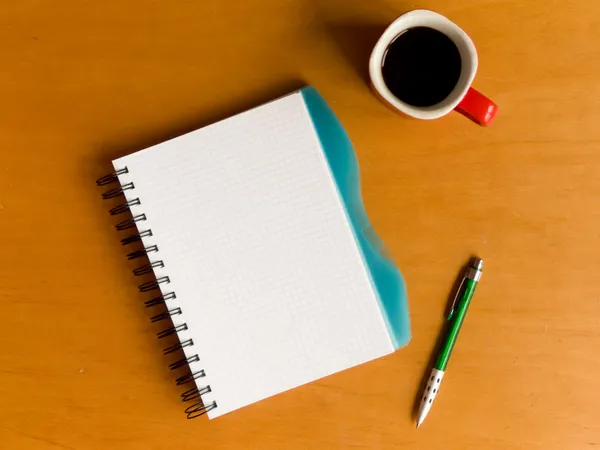 Cup of coffee and notebook