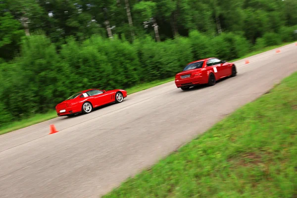 Red sport cars in action