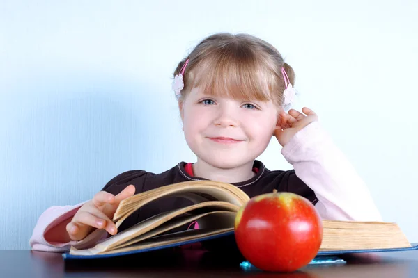 Little girl with apple and books