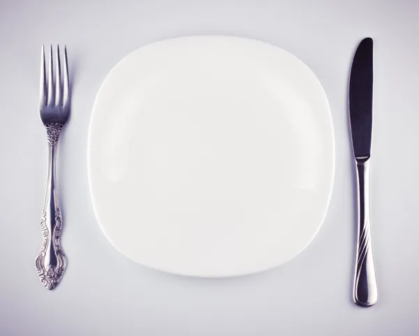 Empty white dish knife and fork