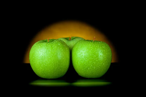 Green apples in yellow light