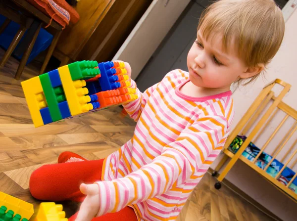 A child plays with toy blocks