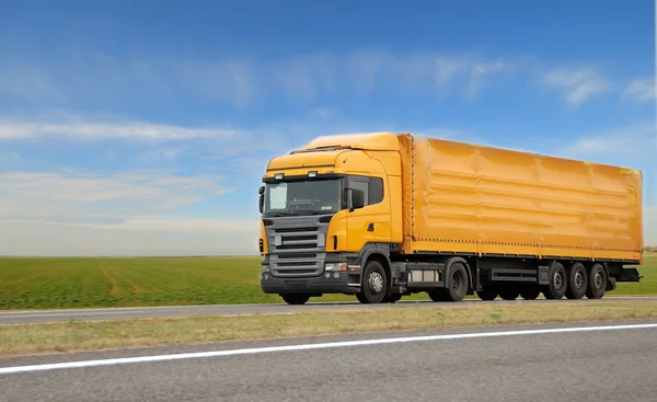 Orange lorry with trailer