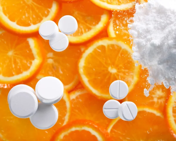 White pills with oranges