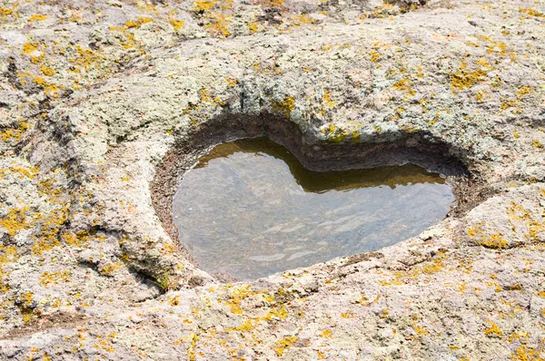 Puddle heart in stone