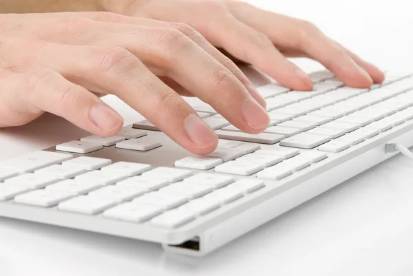 Male hands typing on a keyboard