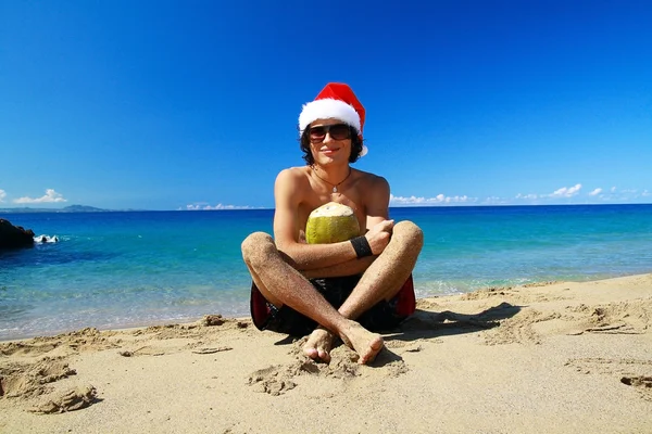 Santa Claus with coco on beach