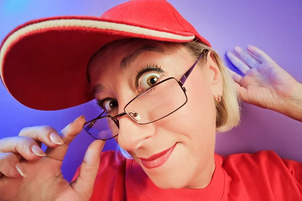 Funny surprised woman portrait in a cap