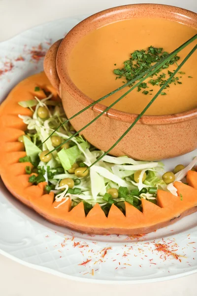 Pumpkin soup decorated with greens