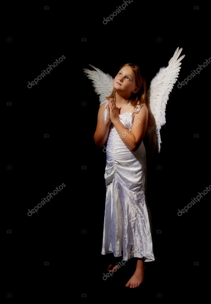 Pure and innocent little angel fairy girl praying —