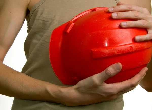 Men holds a red building helmet
