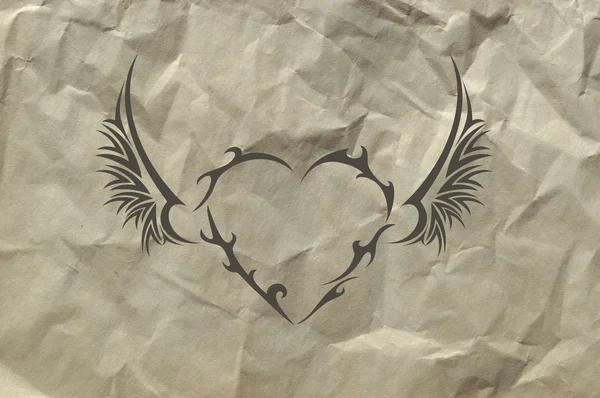 Tribal heart on the crushed paper
