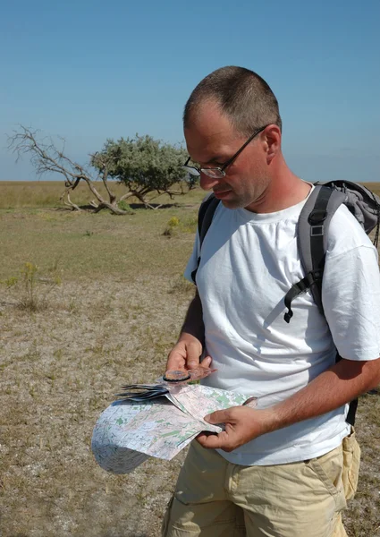 Man with map and compas - orienteering
