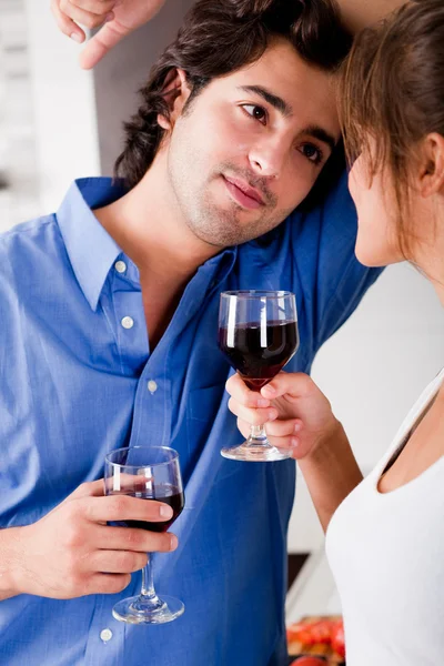 Man looking his wife with wine
