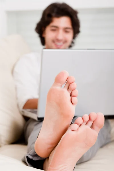 Computer, focus on man foot