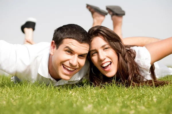Couple laying down in the grass