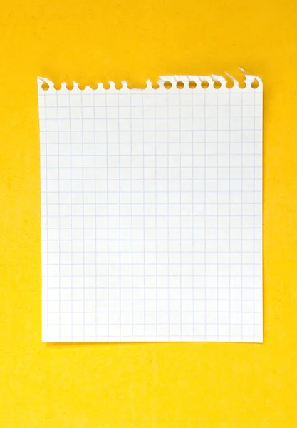 Sheet of white lined paper on the yellow