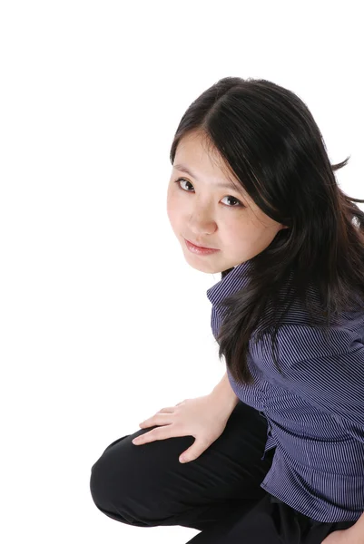 Young chinese girl squatting on the floo by Vasily Ryabov Stock Photo