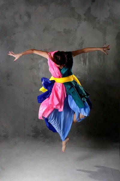 Young dancing girl in colorful dress