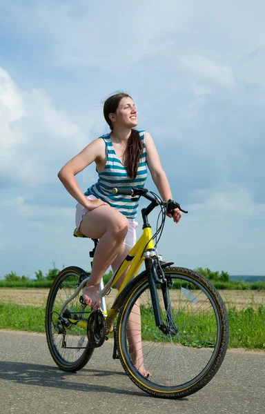 Girl goes on bicycle
