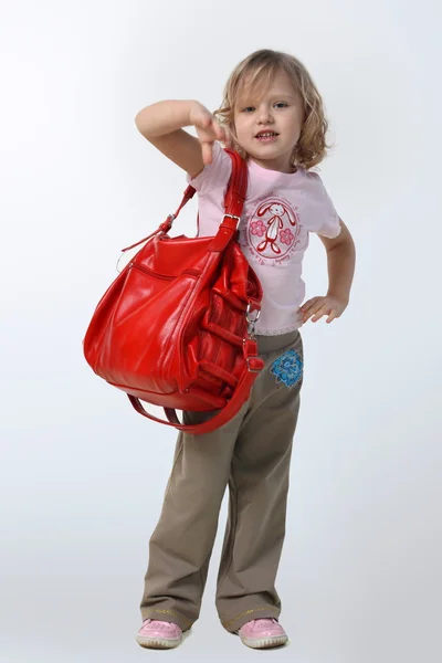 Little girl with a red bag