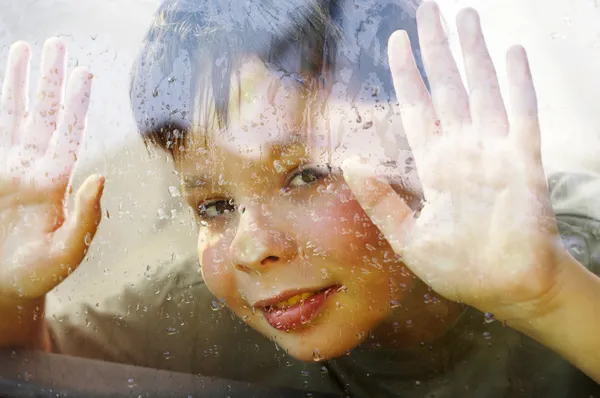Child and window on a wet rainy day — Stock Photo #1191584