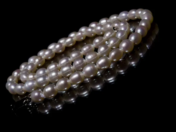 Necklace from pearls on a black backgrou