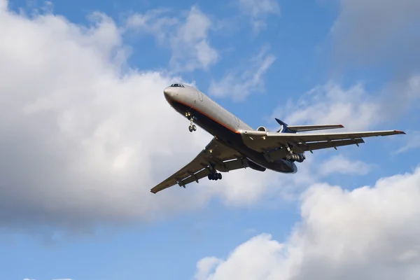 Passenger airplane landing on blue sky w