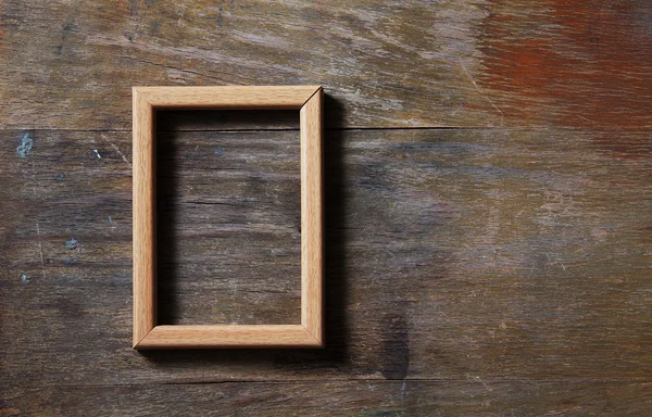 Empty frame on wooden background