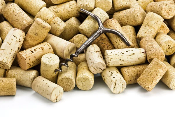 Old corkscrew and wine corks