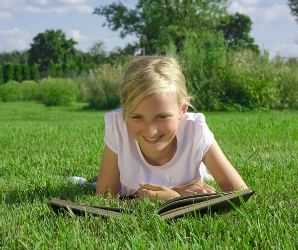Smiling beautiful girl reading book