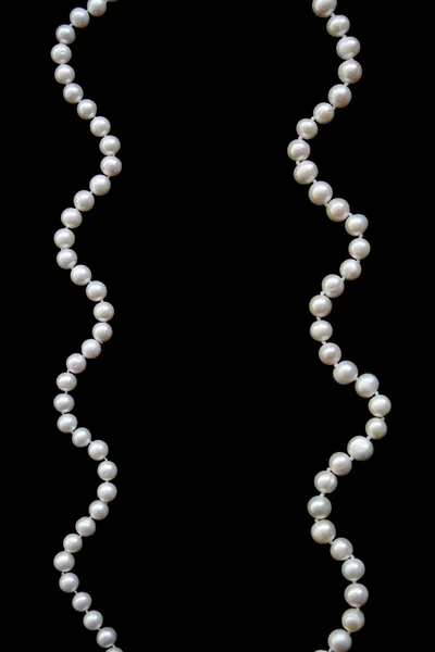 White pearls on the black silk