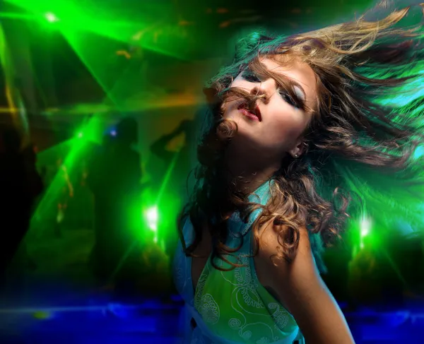 Beautiful young woman dancing in the nightclub