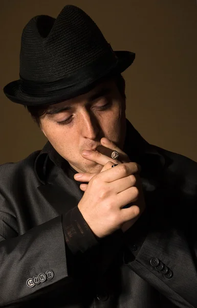 Gangster man smokes cigar in retro bar